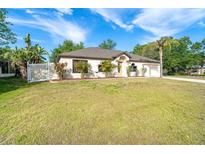 Charming one-story home with a well-manicured lawn and mature landscaping in a desirable neighborhood at 3593 Birmingham Ln, North Port, FL 34288