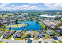 Scenic aerial view of home situated near a serene lake, showcasing the tranquil surroundings and neighborhood at 4115 Hemingway Dr, Venice, FL 34293