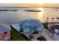 Lovely waterfront home featuring a backyard pool, a spacious driveway, and a beautiful view of the ocean at 1900 Illinois Ave, Englewood, FL 34224