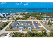 Stunning aerial view of a waterfront community with beautiful blue water, highlighting the home's coastal location at 1965 Louisiana Ave, Englewood, FL 34224