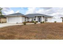 Charming single-story home with a clean landscape design and an attached two-car garage at 2125 Floribanna St, North Port, FL 34287