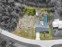 Beautiful home boasts a private pool, surrounded by lush greenery, and located on an oversized lot at 7180 Quarry St, Englewood, FL 34224