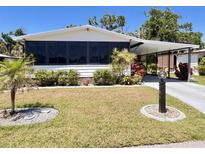 Charming single-story home featuring a covered parking area and meticulously maintained landscaping at 786 Heathercreek Ct, Englewood, FL 34223