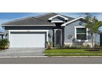 Charming single-Gathering home with a two-car garage, well-maintained lawn, and inviting front entrance at 8244 Shore Lake Dr, Englewood, FL 34224