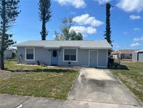 Charming single-story home with a well-maintained front yard and a convenient private driveway at 13561 Darnell Ave, Port Charlotte, FL 33981