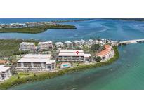 Stunning aerial view of waterfront condominiums, showcasing the coastal setting and community amenities at 1501 Beach Rd # 303, Englewood, FL 34223