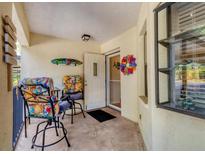 Charming front porch with comfortable seating, perfect for enjoying the outdoors at 507 Pine Hollow Cir # 507, Englewood, FL 34223