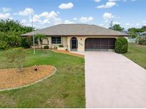 Charming single-story home with a well-maintained lawn and inviting curb appeal at 7393 Mamouth St, Englewood, FL 34224