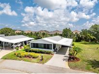 Well-maintained single-story home features mature landscaping, a carport and separate garage at 867 Cascade Ct, Englewood, FL 34223