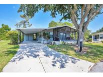 Charming single-story home with a covered parking and inviting screened-in lanai at 878 Fawnspring Ct, Englewood, FL 34223