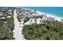 Gorgeous aerial view of the home and surrounding neighborhood near the sandy beach and the Gulf of Mexico at 95 Coquina Ln, Englewood, FL 34223