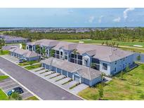 New condos featuring attached garages, lush landscaping, golf course view, and a modern neutral color scheme at 12470 Wellen Golf St # 108, Venice, FL 34293