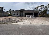 New construction home with a spacious three car garage and block construction at 14 Current Ln, Placida, FL 33946