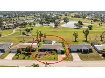 Charming single-story home with a screened lanai, lush landscaping and access to a golf course and pond at 146 Rotonda Cir, Rotonda West, FL 33947