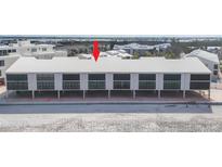 Bright, modern beach condominium complex with a metal roof and impact-resistant windows at 2700 N Beach Rd # B205, Englewood, FL 34223