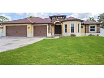 Charming home featuring a well-maintained lawn and a two-car garage at 2758 Morrietta Ln, North Port, FL 34286