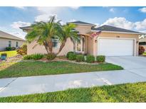 Charming single-story home with well-manicured lawn and lush tropical landscaping in a sunny locale at 278 Crystal River Dr, Englewood, FL 34223