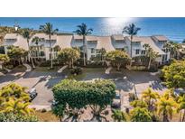 Beautiful condominiums with lush landscaping, an inviting driveway, and peekaboo ocean views at 5000 Gasparilla Rd # 8B, Boca Grande, FL 33921
