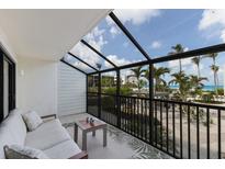 Relaxing screened-in balcony with comfortable seating and beautiful views of the beach at 5700 Gulf Shores Dr # B-137, Boca Grande, FL 33921