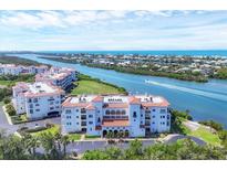 Beautiful exterior of condo building featuring red tile roof and well-maintained landscaping at 11100 Hacienda Del Mar Blvd # G-304, Placida, FL 33946
