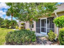 Charming single-story home with screened front porch and lush landscaping at 4225 Fairway Dr, North Port, FL 34287