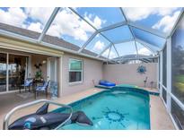 Beautiful pool with a unique layout, in screened enclosure, and outdoor seating area at 4225 Fairway Dr, North Port, FL 34287