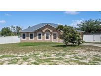 Charming single-story home with a manicured lawn and inviting curb appeal, fenced yard at 5510 Moongate Rd, Spring Hill, FL 34606
