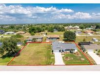 Expansive lot showcases a home with a large lawn and extra space, all enclosed by a red boundary line at 7048 Inland St, Englewood, FL 34224