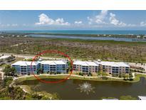 Condo community with beautiful landscaping, lake with fountain, and ocean views from upper floors at 8405 Placida Rd # 406, Placida, FL 33946