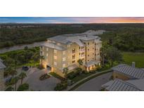 Stunning condominium complex featuring multiple stories, a metal roof, and serene waterfront views at 10521 Amberjack Way # 303, Englewood, FL 34224