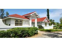 Charming single-Gathering home with a red tile roof and manicured front yard at 365 Capstan Dr, Placida, FL 33946
