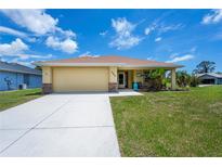 Charming single-story home featuring an attached garage and well-maintained lawn at 9325 Crugar Ter, Englewood, FL 34224