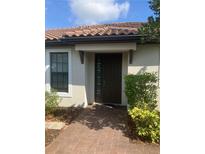 Inviting front door entrance featuring a brick pathway and beautiful landscaping at 10258 Morning Mist Ln, Sarasota, FL 34241