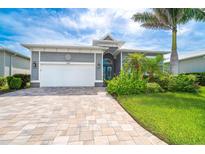 Charming single Gathering home with a well manicured lawn and brick driveway at 10487 Coquina Ct, Placida, FL 33946