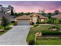 Charming home featuring a well-manicured lawn, neutral paint, and a two-car garage at 127 Jennifer Dr, Rotonda West, FL 33947