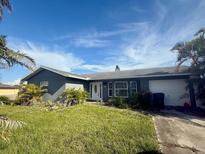 Charming single-story home with a well-manicured lawn and attached garage at 133 Paddington Rd, Venice, FL 34293