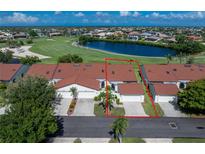 View of a well-maintained home with a red tile roof, tidy landscaping, and attached garage in a golf course community at 1640 Atares # 23, Punta Gorda, FL 33950