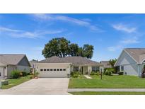 Charming single-story home with a two-car garage, well-maintained lawn, and mature landscaping at 237 Park Forest Blvd, Englewood, FL 34223