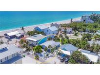 Aerial view of charming beach home with turquoise ocean backdrop at 70 Wilhelm Dr, Englewood, FL 34223