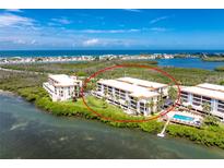 Beautiful waterfront condos featuring pristine landscaping, lush greenery, and waterfront access at 1701 Beach Rd # 207, Englewood, FL 34223