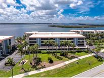 Stunning waterfront condo complex boasting lush landscaping and picturesque water views at 1701 Beach Rd # 207, Englewood, FL 34223