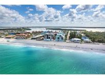 Beautiful aerial view of the beach and beachfront condos with clear turquoise water at 50 Meredith Dr # 9, Englewood, FL 34223