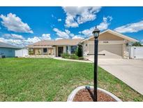 Charming single-story home with well-manicured lawn and stone accents, offering a welcoming curb appeal at 7218 Darlington St, Englewood, FL 34224