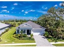 Charming single-story home boasting a well-manicured lawn, neutral colors, and a spacious two-car garage at 11044 Hogan Cir, Englewood, FL 34223