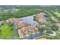Wonderful aerial view of this lovely residential community with a river, lush greenery, and a community pool at 2004 Longpointe Cir # E2, Venice, FL 34293