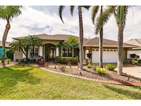 Single-story house with a landscaped yard and palm trees at 254 Rotonda E Blvd, Rotonda West, FL 33947