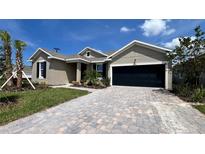 New construction home exterior featuring a 2-car garage and landscaping at 7490 Sea Manatee St, Parrish, FL 34219