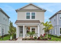 Charming two-story home featuring a welcoming front porch and beautifully landscaped front yard at 168 Eagleston Ln, Lakewood Ranch, FL 34240