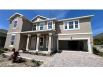 Two-story house with a neutral color scheme and a three car garage at 7446 Sea Manatee St, Parrish, FL 34219