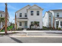 Charming two-story home boasts a modern facade, well-manicured landscaping, and a welcoming light blue front door at 176 Eagleston Ln, Lakewood Ranch, FL 34240